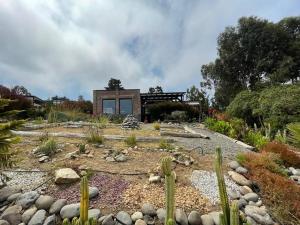 um jardim com uma casa ao fundo em Amplia casa frente al mar, camino a Punta de Lobos em Pichilemu