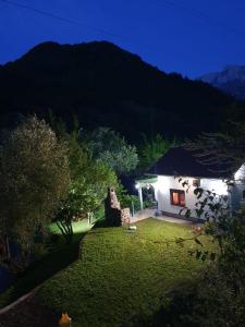 a white house with a garden at night at Villa on the lake near Mostar in Jablanica