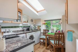 Hillside Cottage في باث: مطبخ مع حوض وغسالة صحون