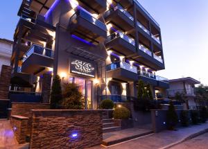 a building with a sign on the side of it at SKS Luxury Suites & Rooms in Paralia Katerinis