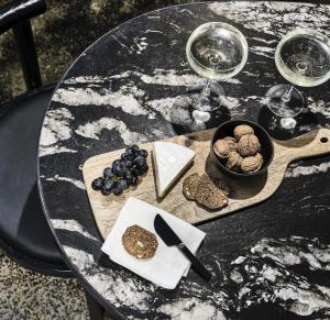 a wooden table topped with a glass of wine at Melbourne City Apartment Hotel in Melbourne