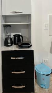a black dresser with a blender on top of it at Adhara Apart in Puerto Iguazú