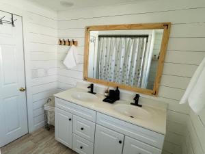 a bathroom with a sink and a mirror at Charming Cottage with Fenced Backyard Pet Friendly in Rehoboth Beach