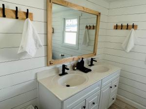 a bathroom with a sink and a mirror at Charming Cottage with Fenced Backyard Pet Friendly in Rehoboth Beach