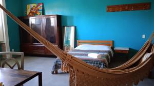 a bedroom with a bed and a hammock at Chez Laurel in Rio de Janeiro