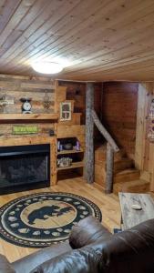 a living room with a fireplace in a log cabin at Woodard Cabin in Cullowhee