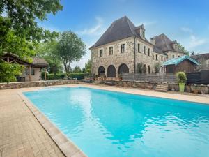 an estate with a swimming pool in front of a building at Lively holiday home with private pool in Sainte-Trie