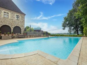 a large swimming pool in front of a building at Lively holiday home with private pool in Sainte-Trie