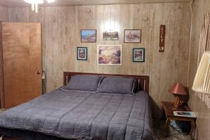 a bedroom with a large bed and pictures on the wall at King's Cabin in Wilsonia