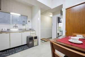 a kitchen with a table with a red table cloth at G&R House 102 in Tokyo