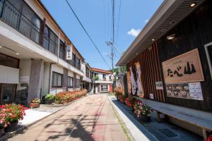 una calle vacía con flores al lado de un edificio en Guesthouse Neruyama, en Nagato