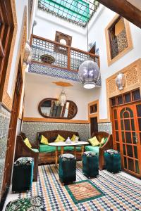 a lobby of a hotel with a table and chairs at Riad Dar Barae in Fès al Bali