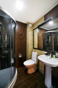 a bathroom with a toilet a sink and a shower at Kalasi Hotel in Tbilisi City