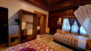 a bedroom with a bed and a tv in a room at Longtail Beach Resort in Thong Nai Pan Yai