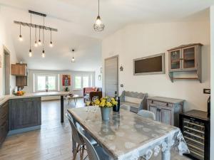 a kitchen with a table with yellow flowers on it at Rural apartment in Matelica with shared pool in Matelica