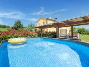 a swimming pool in front of a house at Rural apartment in Matelica with shared pool in Matelica