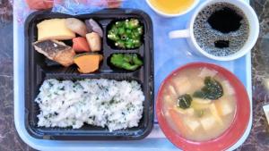 a lunch box with rice and vegetables and a bowl of soup at Toyoko Inn Osaka Kadoma-shi Ekimae in Osaka