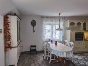 a kitchen with a table and chairs in a kitchen at BALCON Apartments in Bled