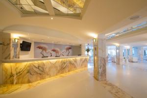 a lobby with a wall mural of pink flamingos at Iberostar Ciudad Blanca in Port d'Alcudia