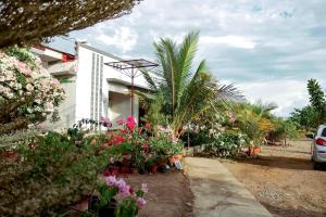 a house with flowers and plants in front of it at Airport View Hotel Vigan in Vigan