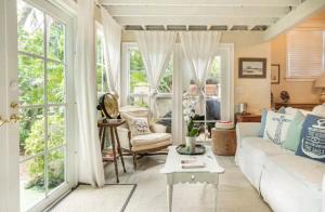 a living room with a couch and a table at Chateau Gardens in Lake Worth