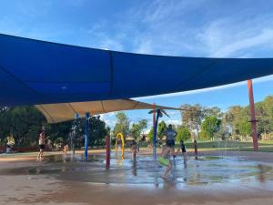 a group of children playing in a water park at Popular Central Location I NEW LINEN I Gated Estate I STAY DUBBO in Dubbo