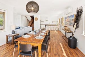 a dining room and living room with a table and chairs at Gypsy Rise in Dunsborough