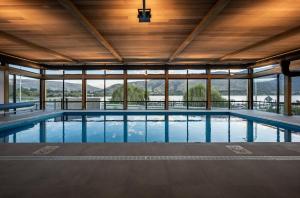 a swimming pool in a building with windows at Luxurious Lakefront Penthouse in Wanaka