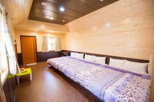 Postel nebo postele na pokoji v ubytování Xiaoliuqiu Happy House B&B