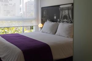 Säng eller sängar i ett rum på Infinito Hotel