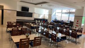 a classroom with tables and chairs in a cafeteria at Toyoko Inn Osaka Tsutenkaku Mae in Osaka