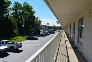 a balcony of a building with cars parked in a parking lot at Motel 6-Chicopee, MA - Springfield in Chicopee