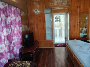 a bedroom with a bed and a tv in it at Youthok Guest House in Leh
