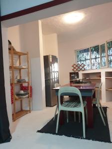 a kitchen with a table and chairs in a room at Le Dhow in Moroni