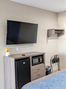 a room with a large flat screen tv on a wall at Holiday Inn motel in Aransas Pass