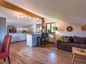 a living room and kitchen with a couch and a table at Ferienwohnungen beim Silbergersee in Oberaudorf