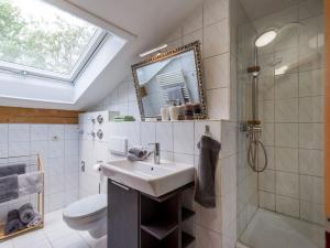 a bathroom with a sink and a shower and a mirror at Ferienwohnungen beim Silbergersee in Oberaudorf