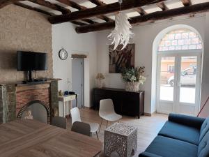 ein Wohnzimmer mit einem blauen Sofa und einem Kamin in der Unterkunft AZUREO - Terrasse du golfe in Morsiglia