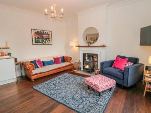 a living room with two couches and a fireplace at 8 Pedwell Way in Berwick-Upon-Tweed
