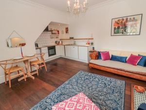 a living room with a couch and a table at 8 Pedwell Way in Berwick-Upon-Tweed