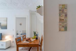 a dining room with a wooden table and chairs at Apt 200 meters from the beach id in Blanes