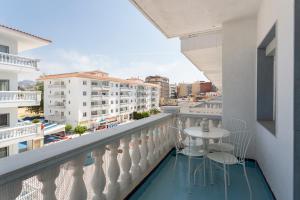 a balcony with a table and chairs on a building at Apt 200 meters from the beach id in Blanes
