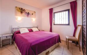 a bedroom with a purple bed and a window at Costa Nova in Jávea