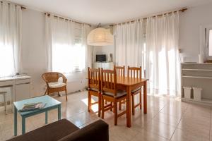 a living room with a table and a dining room at Apartamento Sant Felix in Blanes