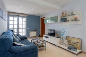 聖安東尼奧·德·卡隆的住宿－Apartament Sant Antoni de Calonge，客厅配有蓝色的沙发和电视