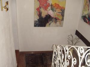 a painting hanging on a wall next to a staircase at B&B Elfi in Salzburg +1 photo