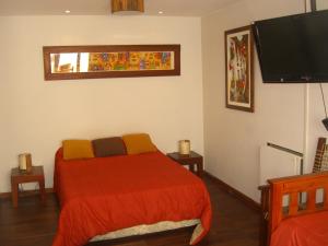 a bedroom with a bed and a flat screen tv at Depto Tipo Apart in Salta