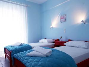 Postel nebo postele na pokoji v ubytování Hotel Asimina Laganas