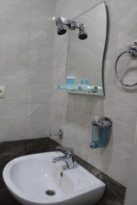 a bathroom with a sink and a mirror at Hotel Rabati in Akhaltsikhe