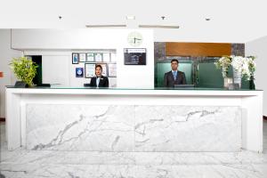 a marble counter in an office with two men at Yogi Executive, Navi Mumbai in Navi Mumbai